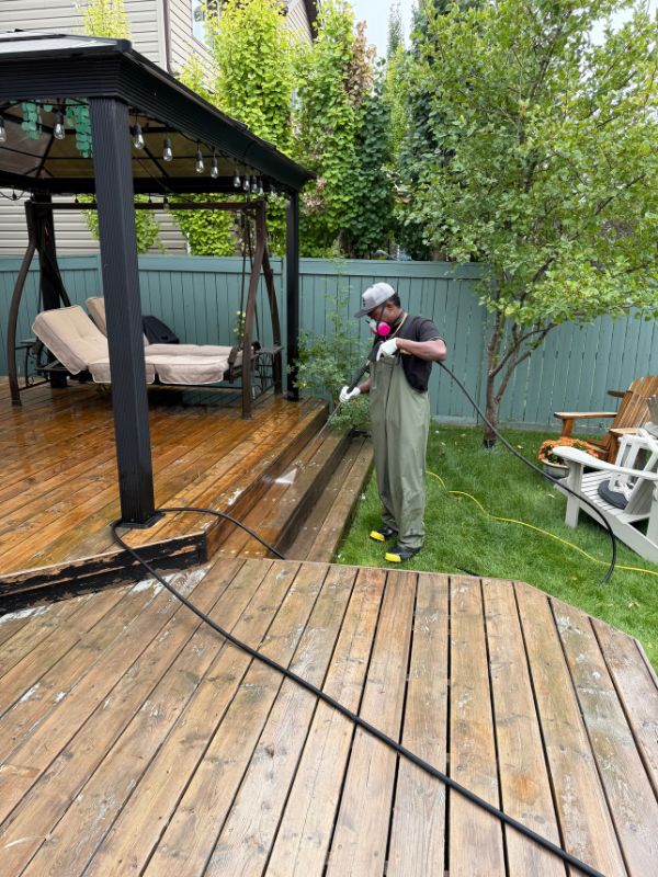 Professional pressure washing in Calgary Alberta - cleaning a residential driveway.