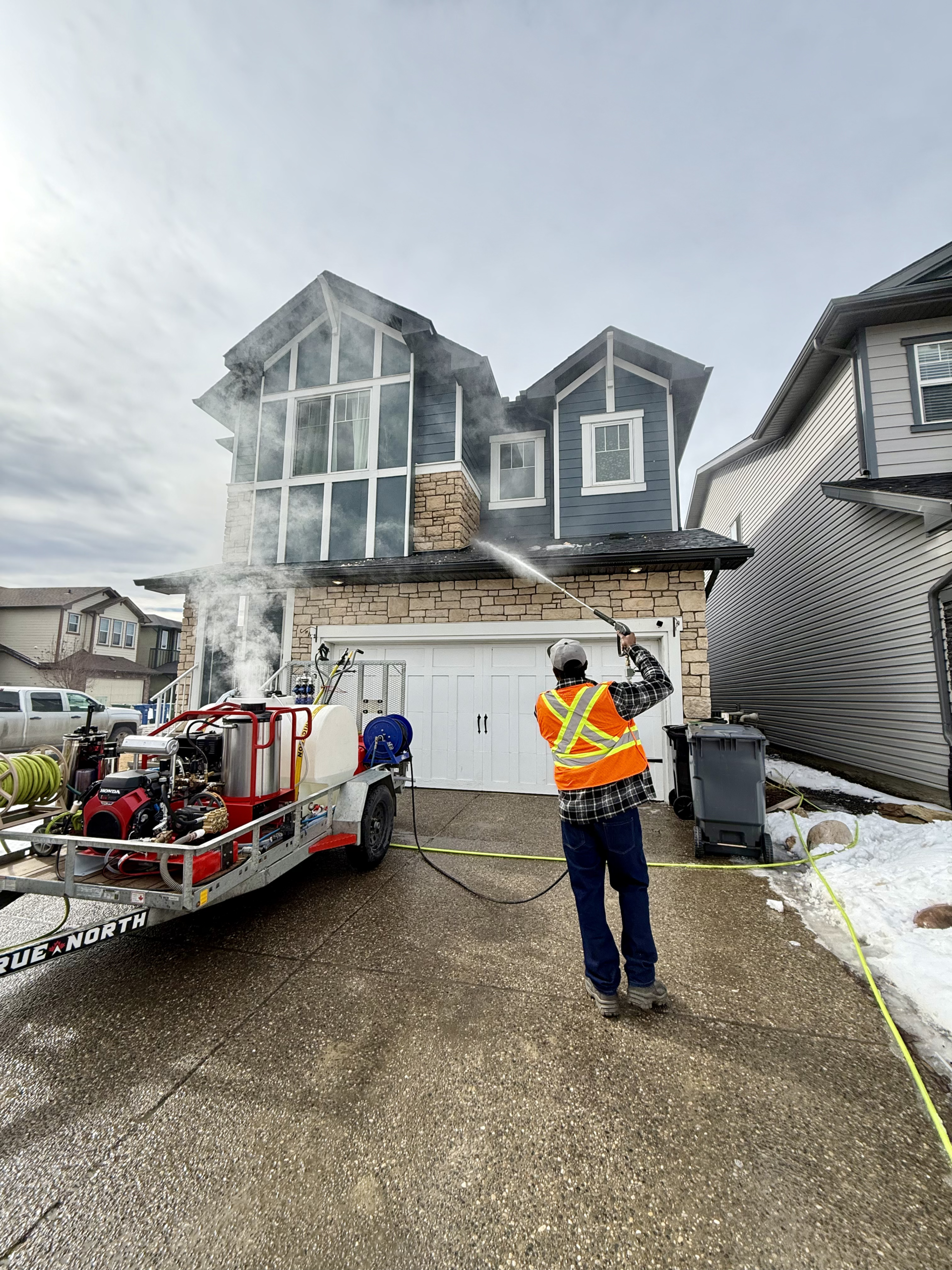 Professional exterior cleaning technician preparing for a property cleaning project